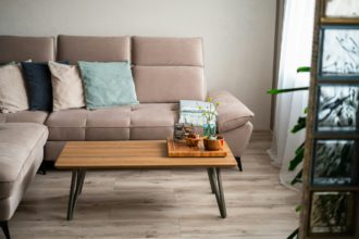 Bright living room interior. Comfortable couch with decorative pillows in natural colors. Coziness