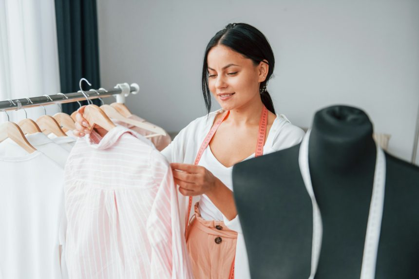 Choosing clothes. Seamstress is in her office