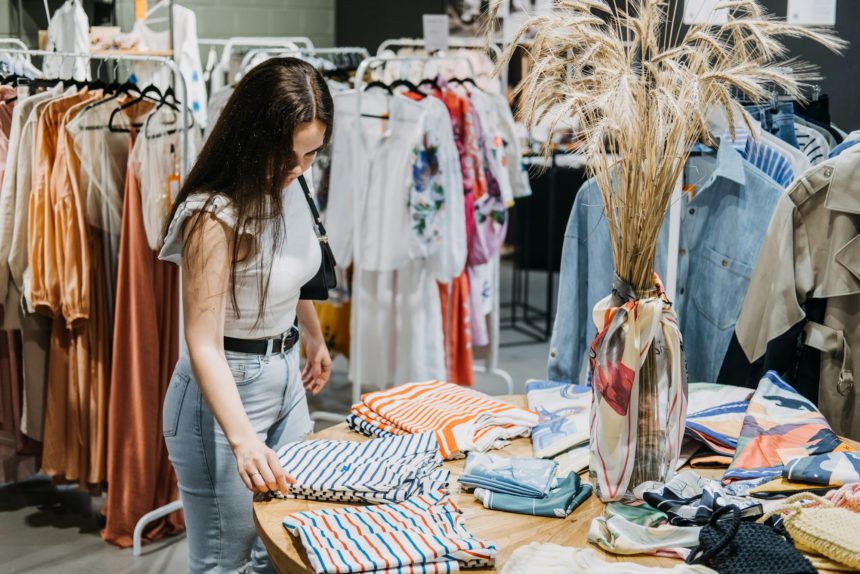 Fast fashion, Woman shopping in cloth store. shopping trendy clothes.